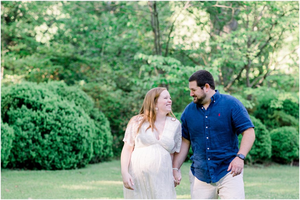 A couple laughing during their maternity session