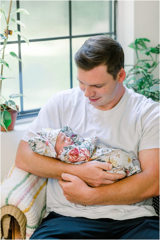Lifestyle Newborn Photography. Dad holding daughter