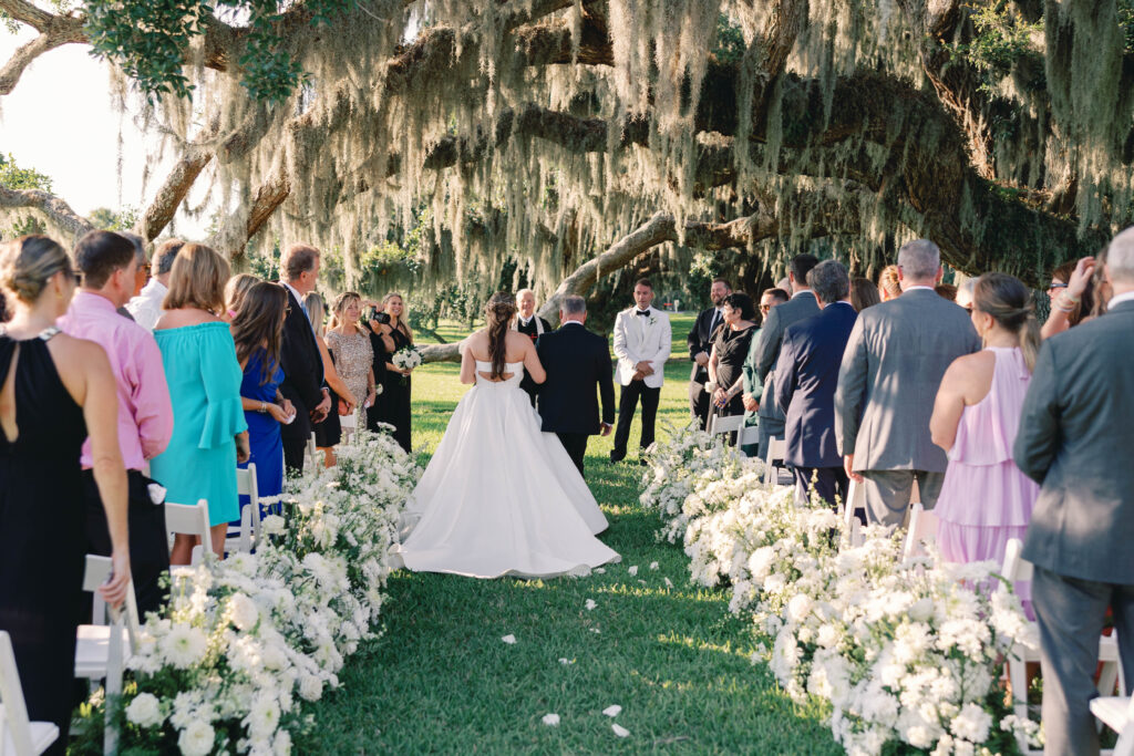 Father and Bride walking down the aisle at a wedding ceremony at Jekyll Beach Club and Resort.