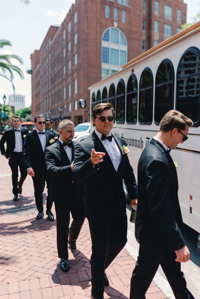 Groomsmen Getting on a trolley in Savannah for a romantic wedding on the marsh. 